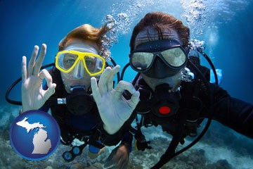 couple enjoying a scuba diving tour - with Michigan icon