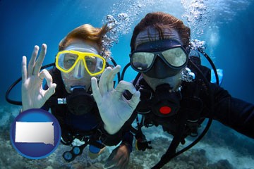 couple enjoying a scuba diving tour - with South Dakota icon